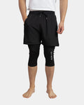 Short de sport caché awra noir porté avec legging intégré jusqu'au genou